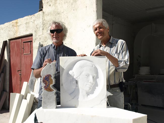 The two marble artists pose with their creations.